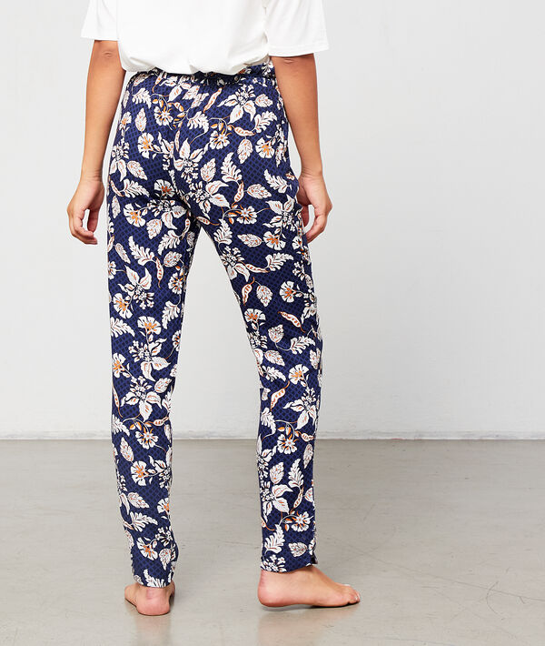 Pantalón estampado floral con pompones decorativos Pantalón estampado floral con pompones decorativos