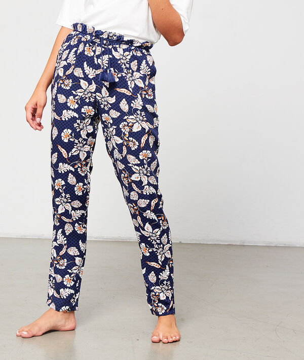 Pantalón estampado floral con pompones decorativos Pantalón estampado floral con pompones decorativos