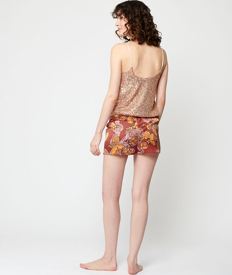 Top con lentejuelas y pompones oro.