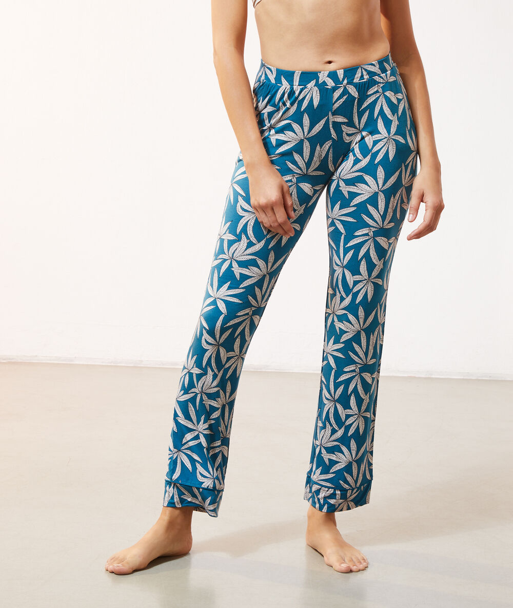 Pantalón estampado hojas turquesa.