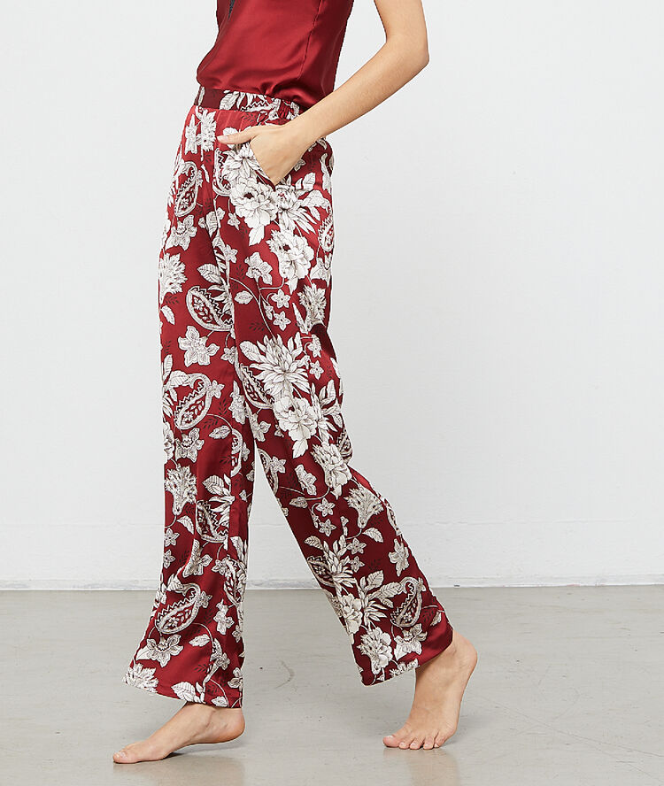 Pantalón holgado estampado floral burdeos.