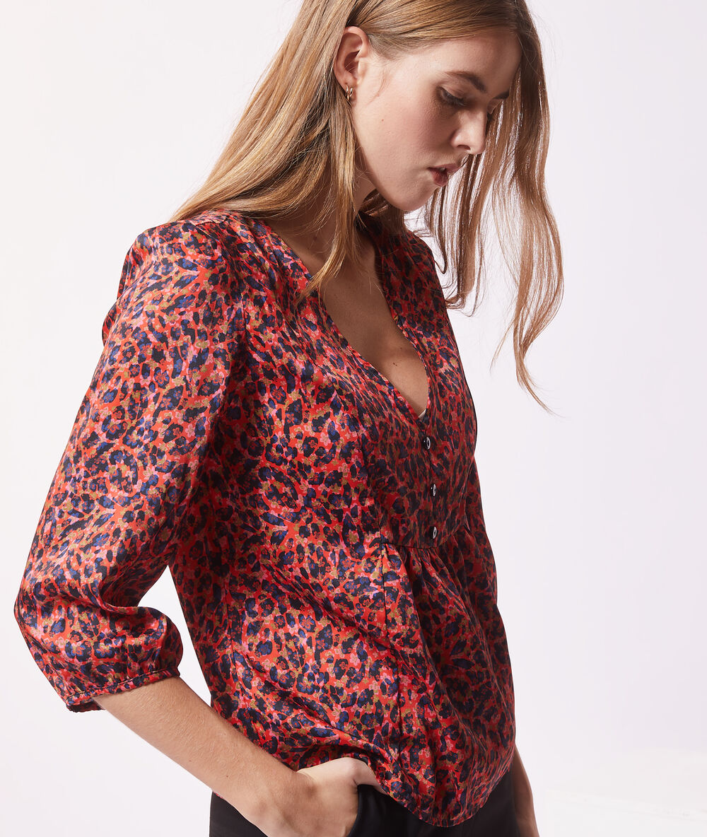 Blouse satinée imprimé fleuri orange.