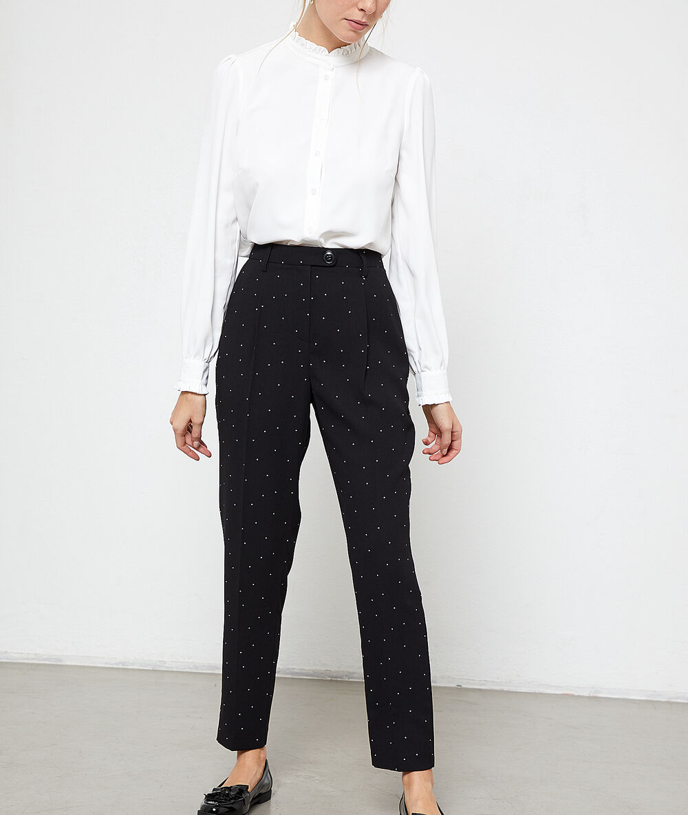 Pantalón de talle alto de lunares negro.