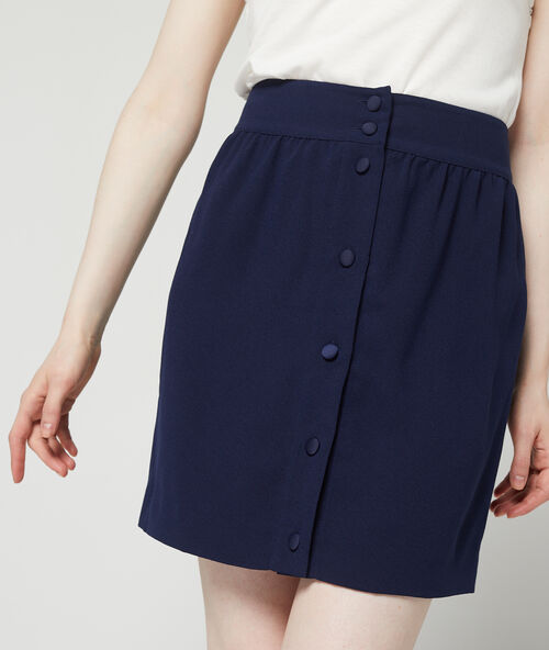 Falda recta con botones delanteros azul marino.