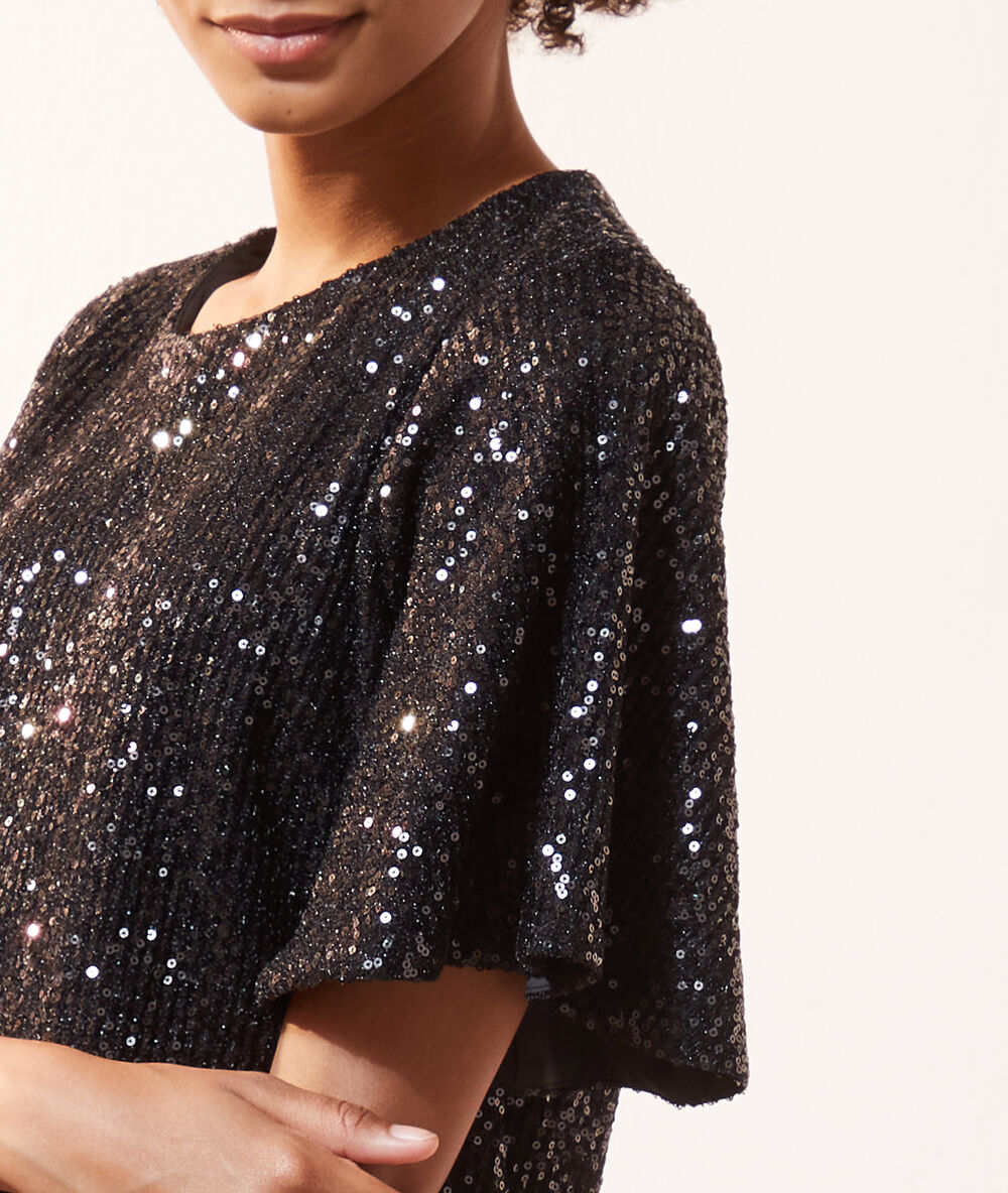 Blouse à sequins, manches volants noir.