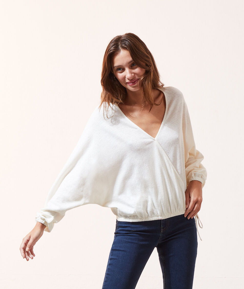 Blusa manga larga escote cruzado crudo.
