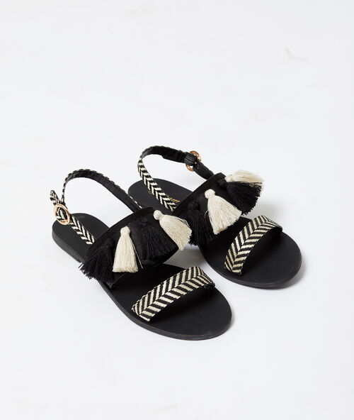Sandalias estampado cebra pompones negro.