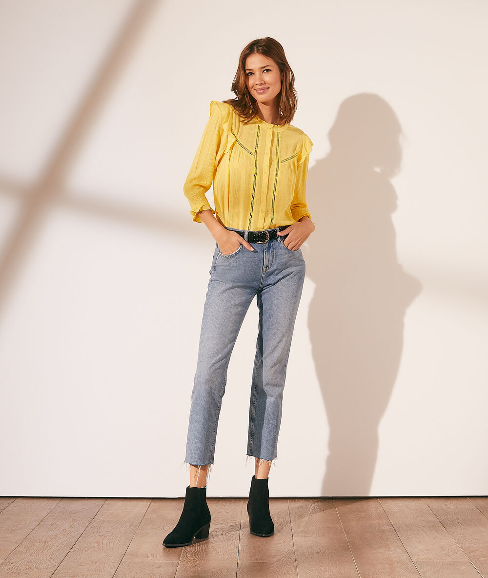 Camisa con volantes amarillo pálido.