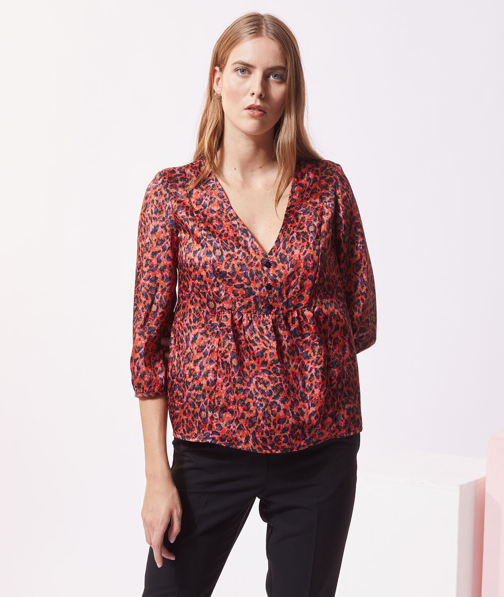 Blouse satinée imprimé fleuri orange.